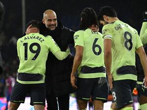 Manchester City's Spanish manager Pep Guardiola (L) celebrates with Manchester City's players after the English Premier League football match between Crystal Palace and Manchester City at Selhurst Park in south London on March 11, 2023. - Manchester City won the game 1-0. (Photo by Ben Stansall / AFP)