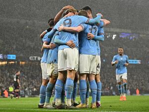 Manchester City's Norwegian striker Erling Haaland celebrates with teammates after scoring their second goal during the English FA Cup quarter-final football match between Manchester City and Burnley at the Etihad Stadium in Manchester, north-west England, on March 18, 2023. (Photo by Oli SCARFF / AFP)