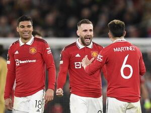 (From L) Manchester United's Brazilian midfielder Casemiro, Manchester United's English defender Luke Shaw and Manchester United's Argentinian defender Lisandro Martinez celebrate at the end of the UEFA Europa league knockout round play-off second leg football match between Manchester United and FC Barcelona at Old Trafford stadium in Manchester, north west England, on February 23, 2023. Manchester United won 2 - 1 against FC Barcelona. (Photo by Oli SCARFF / AFP)
