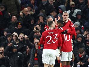 Manchester United's Brazilian midfielder Antony (R) celebrates with teammates after scoring their second goal during the UEFA Europa league round of 16 first leg football match between Manchester United and Real Betis at Old Trafford stadium in Manchester, north-west England, on March 9, 2023. (Photo by DARREN STAPLES / AFP)