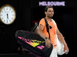 Spain's Rafael Nadal leaves the court after losing to USA's Mackenzie McDonald in their men's singles match on day three of the Australian Open tennis tournament in Melbourne on January 18, 2023. (Photo by MANAN VATSYAYANA / AFP)