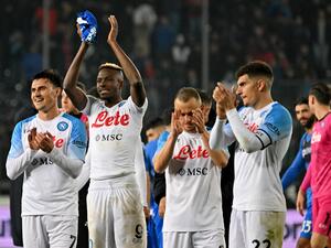 Napoli's Macedonian midfielder Eljif Elmas (L), Napoli's Nigerian forward Victor Osimhen (2nd L), and Napoli's Italian defender Giovanni Di Lorenzo (R) celebrate their 2-0 win at the end of the Italian Serie A football match between Empoli FC and SSC Napoli at the Stadio comunale Carlo Castellani stadium in Empoli on February 25, 2023. (Photo by Alberto PIZZOLI / AFP)