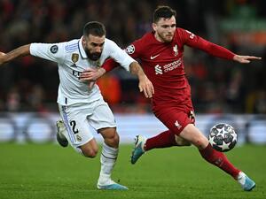 Real Madrid's Spanish defender Dani Carvajal (L) vies with Liverpool's Scottish defender Andrew Robertson during the UEFA Champions League last 16 first leg football match between Liverpool and Real Madrid at Anfield in Liverpool, north west England on February 21, 2023. (Photo by Paul ELLIS / AFP)