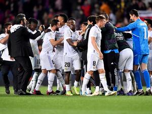 Real Madrid's players celebrate at the end of the Copa del Rey (King's Cup) semi-final second leg football match between FC Barcelona and Real Madrid CF at the Camp Nou stadium in Barcelona on April 5, 2023. (Photo by Pau BARRENA / AFP)