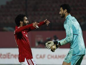 Ahly's Egyptian midfielder Hussein el-Shahat (L) celebrates with Ahly's Egyptian goalkeeper Mohamed el-Shenawy after scoring a goal during the CAF Champions League group B match between Egypt's al-Ahly and South Africa’s Mamelodi Sundowns at the al-Salam stadium in Cairo on February 25, 2023. (Photo by Khaled DESOUKI / AFP)