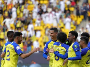 Nassr's Portuguese forward Cristiano Ronaldo (C) and other teammates celebrate after their team scored a goal during the King Cup quarter-final football match between al-Nassr and Abha at Mrsool Park Stadium in Riyadh on March 14, 2023. (Photo by Fayez NURELDINE / AFP)
