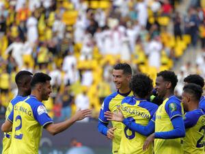 Nassr's Portuguese forward Cristiano Ronaldo (C) and other teammates celebrate after their team scored a goal during the King Cup quarter-final football match between al-Nassr and Abha at Mrsool Park Stadium in Riyadh on March 14, 2023. (Photo by Fayez NURELDINE / AFP)