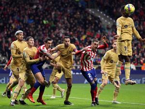 Barcelona's Spanish forward Ansu Fati (R) heads the ball during the Spanish League football match between Club Atletico de Madrid and FC Barcelona at the Wanda Metropolitano stadium in Madrid on January 8, 2023. (Photo by THOMAS COEX / AFP)