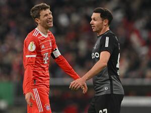 Bayern Munich's German forward Thomas Mueller (L) laughs next to Freiburg's German midfielder Nicolas Hoefler during the German Cup (DFB Pokal) quarter-final football match FC Bayern Munich v SC Freiburg in Munich southern Germany on April 4, 2023. (Photo by CHRISTOF STACHE / AFP)