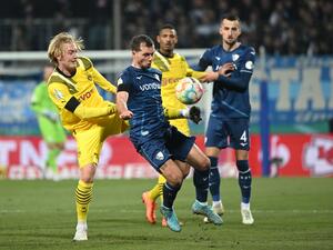 Dortmund's German midfielder Julian Brandt (L) and Bochum's Austrian midfielder Kevin Stoeger (2nd L) vie for the ball during the German Cup (DFB Pokal) football match VfL Bochum v BVB Borussia Dortmund in Bochum, western Germany on February 8, 2023. (Photo by INA FASSBENDER / AFP)