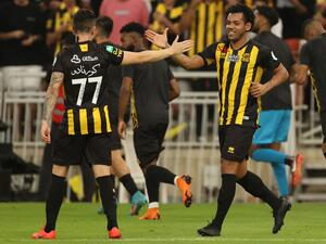 Ittihad's forward Romarinho (R) celebrates his goal with a teammate during a Saudi Pro League football match between al-Ittihad and al-Hilal at the King Abdullah Sports City in Jeddah on May 23, 2022. (Photo by AFP)
