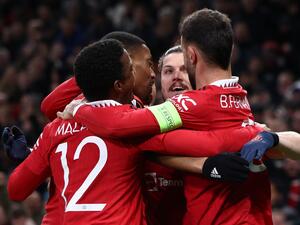 Manchester United's Austrian midfielder Marcel Sabitzer (2R) celebrates scoring the opening goal with during the UEFA Europa league quarter-final, first leg football match between Manchester United and Sevilla at Old Trafford stadium in Manchester, north west England, on April 13, 2023. (Photo by Darren Staples / AFP)