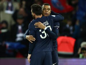 Paris Saint-Germain's Argentine forward Lionel Messi is congratulated by Paris Saint-Germain's French forward Kylian Mbappe after scoring his team's third goal during the French L1 football match between Paris Saint-Germain (PSG) and Lens (RCL) at the Parc des Princes in Paris, on April 15, 2023. (Photo by Anne-Christine POUJOULAT / AFP)