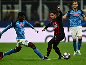 Napoli's Cameroonian midfielder Andre Zambo Anguissa (L) and AC Milan's Algerian defender Ismael Bennacer go for the ball during the UEFA Champions League quarter-finals first leg football match between AC Milan and SSC Napoli on April 12, 2023 at the San Siro stadium in Milan. (Photo by GABRIEL BOUYS / AFP)
