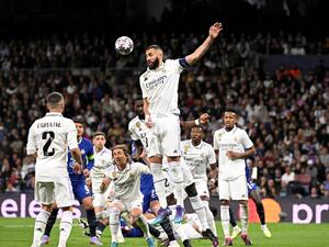 Real Madrid's French forward Karim Benzema heads the ball during the UEFA Champions League quarter final first leg football match between Real Madrid CF and Chelsea FC at the Santiago Bernabeu stadium in Madrid on April 12, 2023. (Photo by JAVIER SORIANO / AFP)