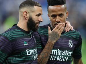 Real Madrid's French forward Karim Benzema and Real Madrid's Brazilian defender Eder Militao (R) talk as they warm up prior the Spanish league football match between Real Madrid CF and RC Celta de Vigo at the Santiago Bernabeu stadium in Madrid on April 22, 2023. (Photo by Thomas COEX / AFP)