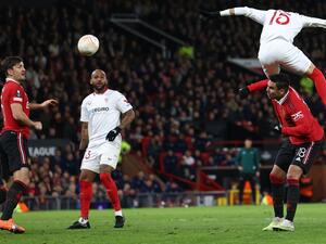 Sevilla's Moroccan forward Youssef En-Nesyri headers the ball to score a second goal, deflected in for an own goal off of Manchester United's English defender Harry Maguire (L) during the UEFA Europa league quarter-final, first leg football match between Manchester United and Sevilla at Old Trafford stadium in Manchester, north west England, on April 13, 2023. (Photo by Darren Staples / AFP)