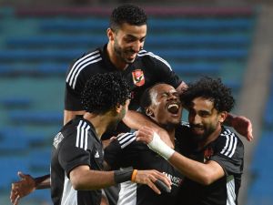 Ahly's South African forward Percy Tau (C) celebrates with teammates after scoring his team's second goal during the CAF Champions League semi-final football match between Tunisia's Esperance Sportive de Tunis and Egypt's Al-Ahly at the Hammadi Agrebi Stadium in Rades on May 12, 2023. (Photo by FETHI BELAID / AFP)