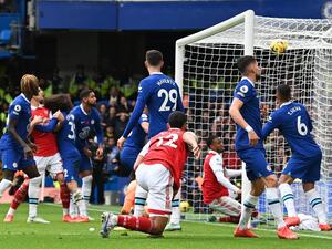 Arsenal's Brazilian defender Gabriel Magalhaes scores his team's first goal during the English Premier League football match between Chelsea and Arsenal at Stamford Bridge in London on November 6, 2022. (Photo by Glyn KIRK / AFP)