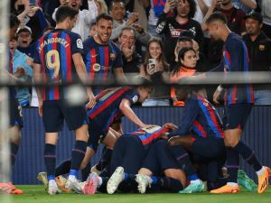 Barcelona's players celebrate their goal scored by Spanish defender Jordi Alba during the Spanish league football match between FC Barcelona and CA Osasuna at the Camp Nou stadium in Barcelona on May 2, 2023. (Photo by LLUIS GENE / AFP)