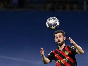Manchester City's Portuguese midfielder Bernardo Silva eyes the ball during the UEFA Champions League semi-final first leg football match between Real Madrid CF and Manchester City at the Santiago Bernabeu stadium in Madrid on May 9, 2023. (Photo by OSCAR DEL POZO / AFP)