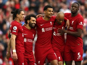 Liverpool's Egyptian striker Mohamed Salah (2L) celebrates with teammates after scoring his team's first goal during the English Premier League football match between Liverpool and Brentford at Anfield in Liverpool, north west England on May 6, 2023. (Photo by DARREN STAPLES / AFP)