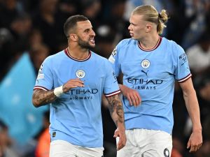 Manchester City's English defender Kyle Walker (L) talks with Manchester City's Norwegian striker Erling Haaland during the UEFA Champions League second leg semi-final football match between Manchester City and Real Madrid at the Etihad Stadium in Manchester, north west England, on May 17, 2023. (Photo by Paul ELLIS / AFP)