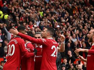 Manchester United's Portuguese midfielder Bruno Fernandes celebrates with teammates after scoring his team first goal during the English Premier League football match between Manchester United and Aston Villa at Old Trafford in Manchester, north west England, on April 30, 2023. (Photo by Oli SCARFF / AFP)