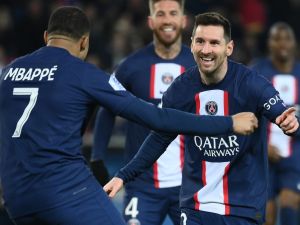Paris Saint-Germain's Argentine forward Lionel Messi (R) celebrates with Paris Saint-Germain's French forward Kylian Mbappe (L) after scoring a goal during the French L1 football match between Paris Saint-Germain (PSG) and FC Nantes at The Parc des Princes Stadium in Paris on March 4, 2023. (Photo by FRANCK FIFE / AFP)