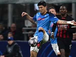 Napoli's South Korean defender Min-jae Kim clears a ball during the UEFA Champions League quarter-finals first leg football match between AC Milan and SSC Napoli on April 12, 2023 at the San Siro stadium in Milan. (Photo by GABRIEL BOUYS / AFP)