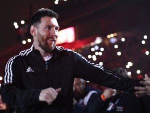 Argentine football player Lionel Messi greets fans during his entrance to the field before the start of Maximiliano Rodriguez's farewell match at the Marcelo Bielsa stadium in Rosario, Argentina on June 24, 2023. (Photo by STRINGER / AFP)
