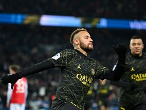 Paris Saint-Germain's Brazilian forward Neymar celebrates with teammates after scoring the opening goal during the French L1 football match between Paris Saint-Germain (PSG) and Stade de Reims at the Parc des Princes stadium in Paris on January 29, 2023. (Photo by Anne-Christine POUJOULAT / AFP)