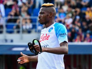 Napoli's Nigerian forward Victor Osimhen takes off his face mask as he celebrates after scoring his side's second goal during the Italian Serie A football match between Bologna and Napoli on May 28, 2023 at the Renato-Dall'Ara stadium in Bologna. (Photo by Vincenzo PINTO / AFP)