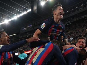 Barcelona's Ivorian midfielder Franck Kessie celebrates with teammates after scoring his team's second goal during the Spanish league football match between FC Barcelona and Real Madrid CF at the Camp Nou stadium in Barcelona on March 19, 2023. (Photo by LLUIS GENE / AFP)