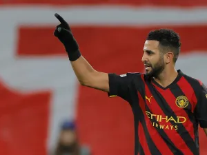 Manchester City's Algerian midfielder Riyad Mahrez celebrates scoring the opening goal during the UEFA Champions League round of 16, first-leg football match between RB Leipzig and Manchester City in Leipzig, eastern Germany on February 22, 2023. (Photo by Odd ANDERSEN / AFP)