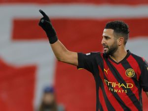 Manchester City's Algerian midfielder Riyad Mahrez celebrates scoring the opening goal during the UEFA Champions League round of 16, first-leg football match between RB Leipzig and Manchester City in Leipzig, eastern Germany on February 22, 2023. (Photo by Odd ANDERSEN / AFP)