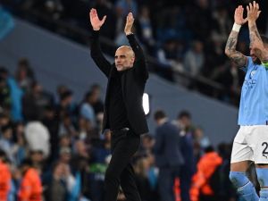 Manchester City's Spanish manager Pep Guardiola (L) and Manchester City's English defender Kyle Walker applauds the fans following the UEFA Champions League second leg semi-final football match between Manchester City and Real Madrid at the Etihad Stadium in Manchester, north west England, on May 17, 2023. Manchester City won the match 4-0. (Photo by Paul ELLIS / AFP)