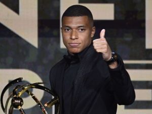 Paris Saint-Germain's French forward Kylian Mbappe thumbs up after receiving the Best Ligue 1 Player award during the 31th edition of the UNFP (French National Professional Football players Union) trophy ceremony, in Paris May 28, 2023. (Photo by Bertrand GUAY / AFP)