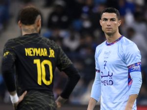 Paris Saint-Germain's Brazilian forward Neymar (L) and Riyadh All-Star's Portuguese forward Cristiano Ronaldo look on during the Riyadh Season Cup football match between the Riyadh All-Stars and Paris Saint-Germain at the King Fahd Stadium in Riyadh on January 19, 2023. (Photo by FRANCK FIFE / AFP)