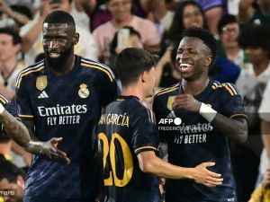 Real Madrid's Brazilian midfielder Vini Jr. (R) celebrates scoring his team's third goal with teammates during the friendly football match between Real Madrid and AC Milan at the Rose Bowl in Pasadena, California, on July 23, 2023. (Photo by Frederic J. BROWN / AFP)