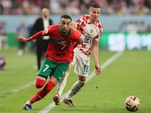 Morocco's midfielder #07 Hakim Ziyech (L) and Croatia's forward #18 Mislav Orsic fight for the ball during the Qatar 2022 World Cup third place play-off football match between Croatia and Morocco at Khalifa International Stadium in Doha on December 17, 2022. (Photo by KARIM JAAFAR / AFP)