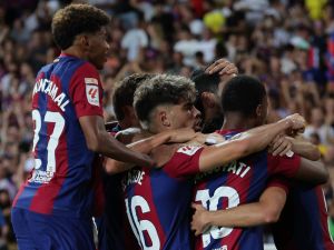 Barcelona's players celebrate their team's first goal during the Spanish Liga football match between FC Barcelona and Cadiz CF at the Lluis Companys Olimpic Stadium in Barcelona on August 20, 2023. (Photo by LLUIS GENE / AFP)