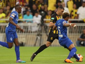 Ittihad's forward Abderrazak Hamdallah (C) is marked by Hilal's defender Ali al-Bulaihi (R) during a Saudi Pro League football match between al-Ittihad and al-Hilal at the King Abdullah Sports City in Jeddah on May 23, 2022. (Photo by AFP)