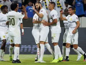 Ittihad's French forward Karim Benzema (C) celebrates with teammates after scoring his team's second goal during the 2023 Arab Club Champions Cup group A football match between Tunisia's Esperance de Tunis and Saudi Arabia's Al-Ittihad at the King Fahd Stadium in Taif on July 27, 2023. (Photo by AFP)