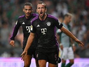 Bayern Munich's English forward #09 Harry Kane celebrates scoring the 0-2 goal with his team-mate Bayern Munich's German midfielder #10 Leroy Sane during the German first division Bundesliga football match between Werder Bremen and FC Bayern Munich in Bremen, northern Germany, on August 18, 2023. (Photo by INA FASSBENDER / AFP)