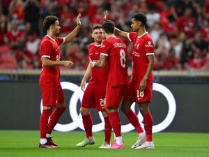 Liverpool's Dutch striker Cody Gakpo (R) celebrates with teammates after scoring a goal against Bayern Munich during the Singapore Festival of Football pre-season friendly match in Singapore on August 2, 2023. (Photo by Mohd RASFAN / AFP)