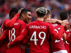 Manchester United's Brazilian midfielder Casemiro (L) celebrates scoring his team third goal during the pre-season friendly football match between Manchester United and Lens at Old Trafford stadium, in Manchester, on August 5, 2023. (Photo by Darren Staples / AFP)