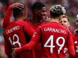 Manchester United's Brazilian midfielder Casemiro (L) celebrates scoring his team third goal during the pre-season friendly football match between Manchester United and Lens at Old Trafford stadium, in Manchester, on August 5, 2023. (Photo by Darren Staples / AFP)