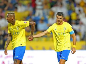 Nassr's Portuguese forward Cristiano Ronaldo walks with Nassr's Brazilian forward Talisca (L) during the 2023 Arab Club Champions Cup semi-final football match between Saudi Arabia's Al-Nassr and Iraq's Al-Shorta at Prince Sultan bin Abdul Aziz Stadium in Abha on August 9, 2023. (Photo by Abdullah Mahdi / AFP)