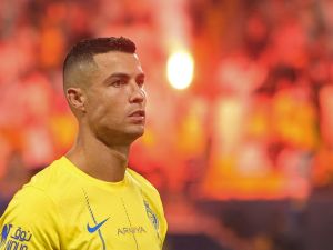 Nassr's Portuguese forward #07 Cristiano Ronaldo stands for the national anthem before the start of the Saudi Pro League football match between Al-Nassr and Al-Taawoun at King Saud University Stadium in Riyadh on August 18, 2023. (Photo by Fayez Nureldine / AFP)